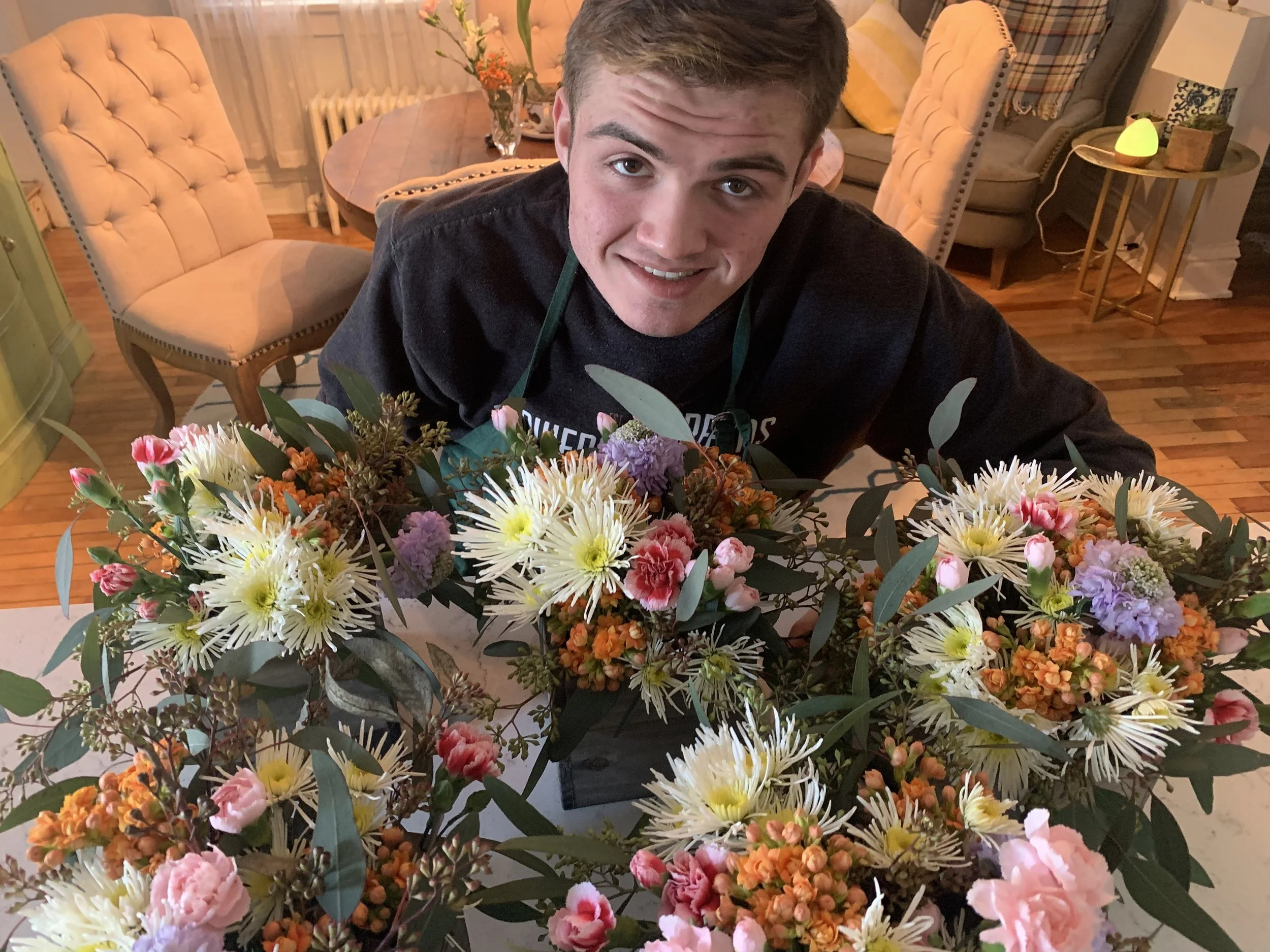 Sean surrounded by several of his arrangements he made for an event.