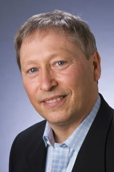 Peter Wayne, PhD wearing light blue shirt with navy jacket