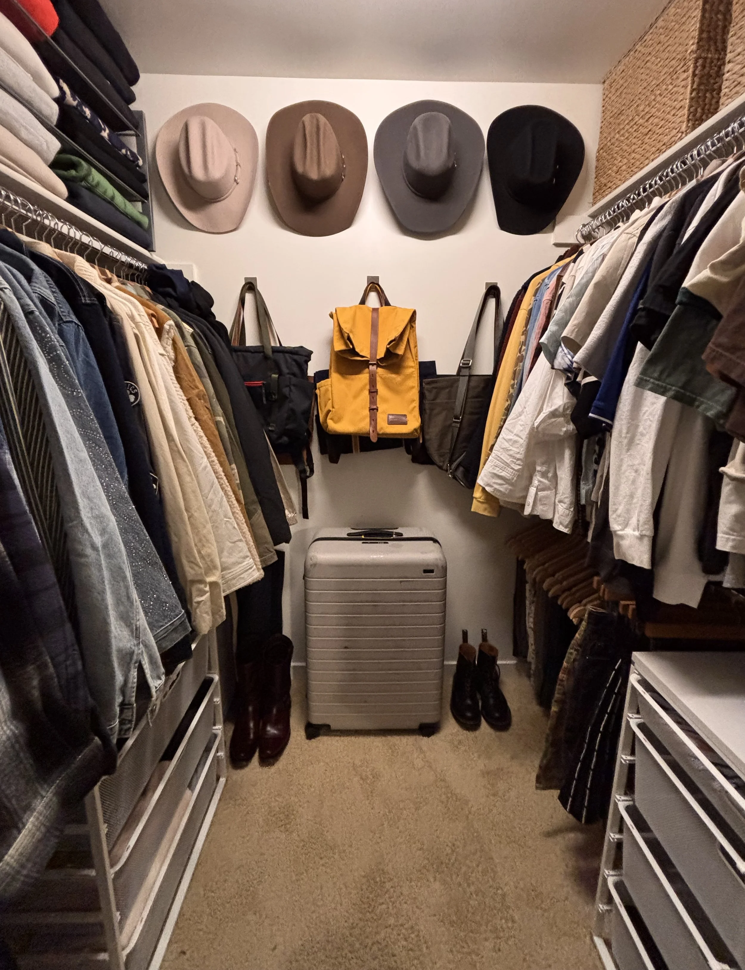 A walk-in closet organized by Adrian Jacob Creative. San Francisco Home Organizer. Professional Unpacking and Organizing.