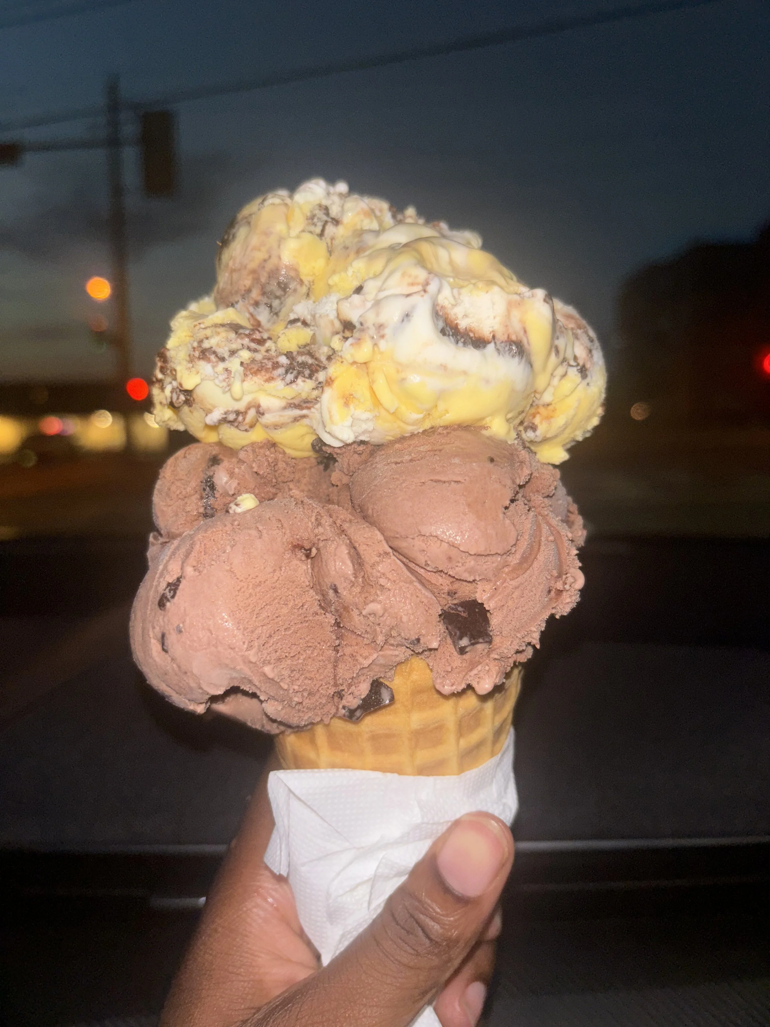 Photo of double scoop of ice cream, on scoop banana boat, and below is a scoop of death by chocolate fro Kawartha Dairy