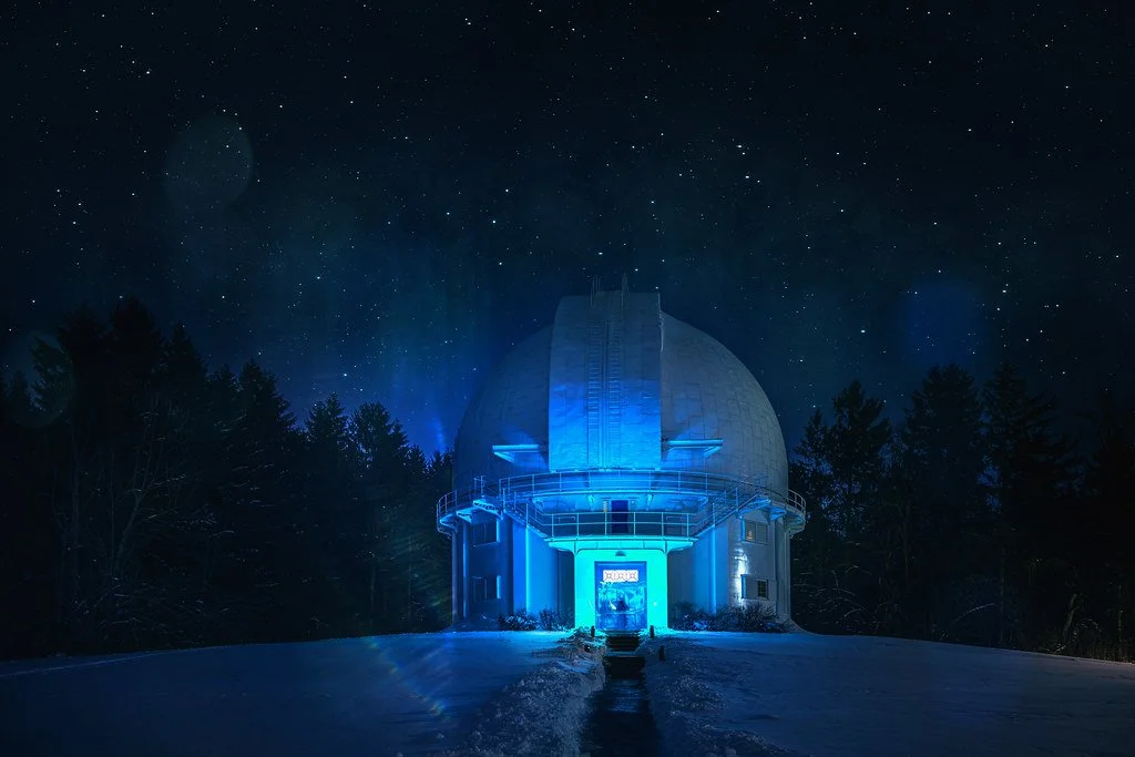 Photo of David Dunlap Observatory at night with the starry sky behind it