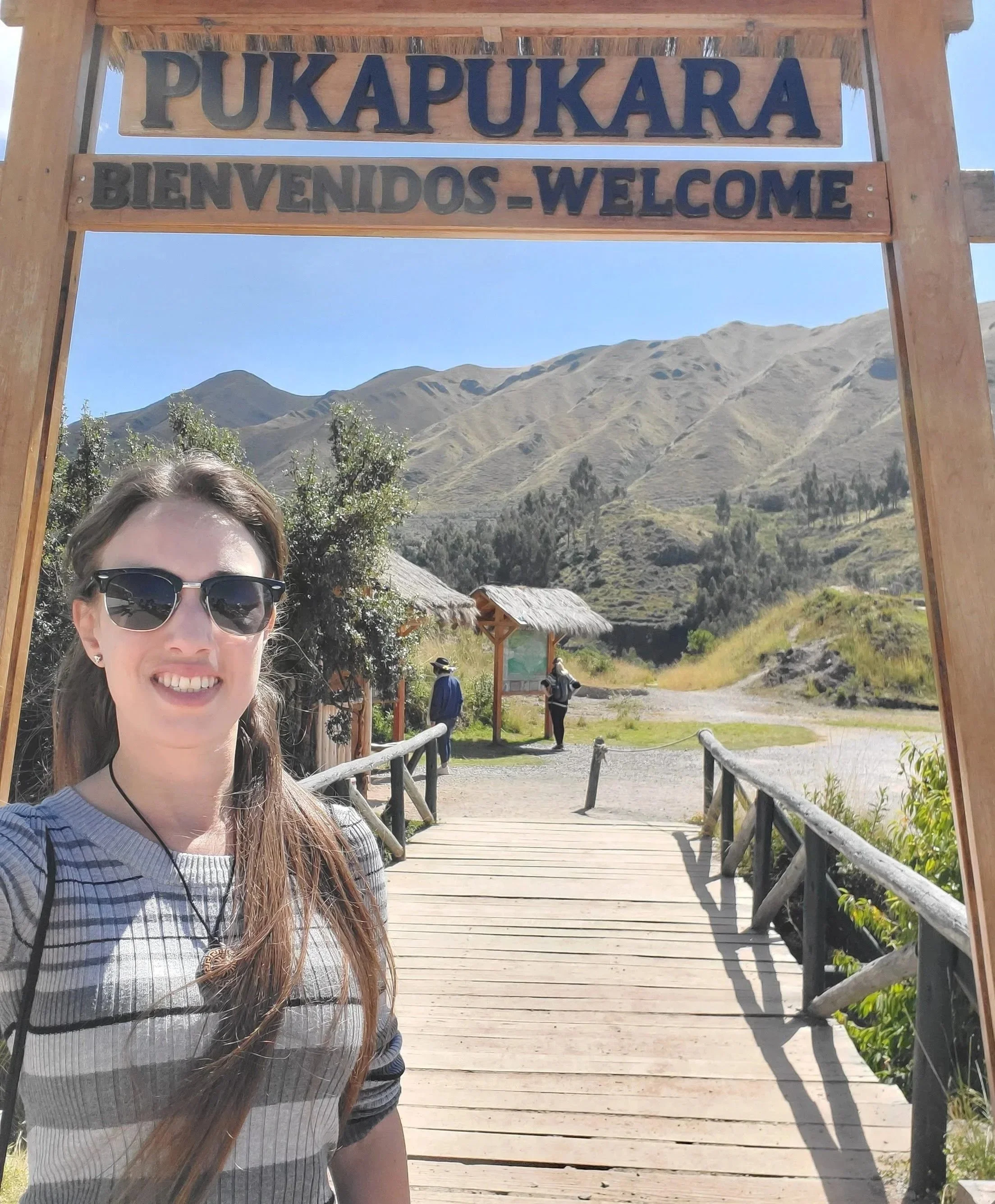 Wendy arriving at the entrance of Puka Pukara, ready to explore the ancient Inca fortress ruins in the Peruvian Andes.