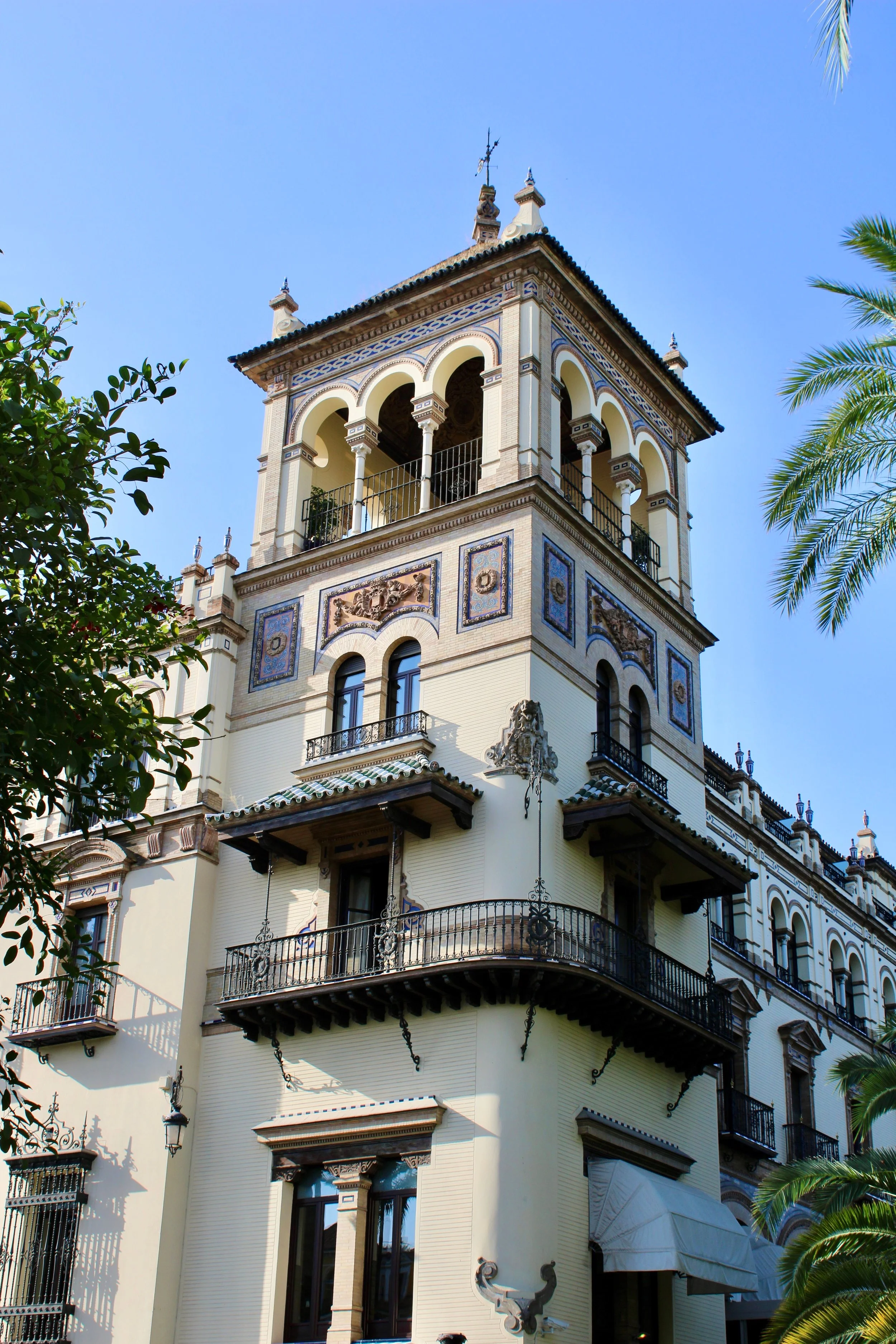 Intricate Moorish architectural arches and lush courtyard gardens at the Royal Alcázar in Seville, Spain.