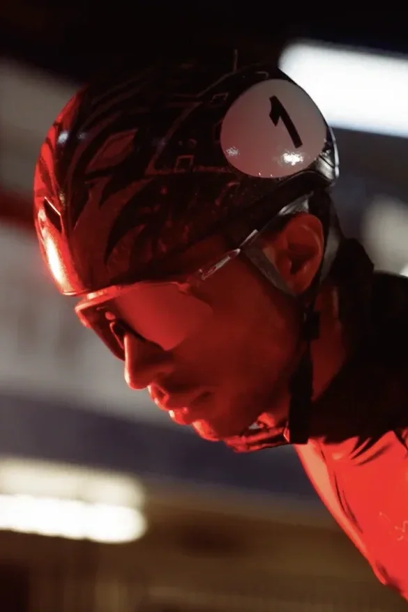 Close-up of a cyclist wearing a helmet with a