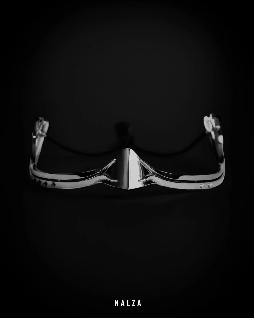A pair of sleek, shiny silver sunglasses against a black background with the word 'NALZA' at the bottom.