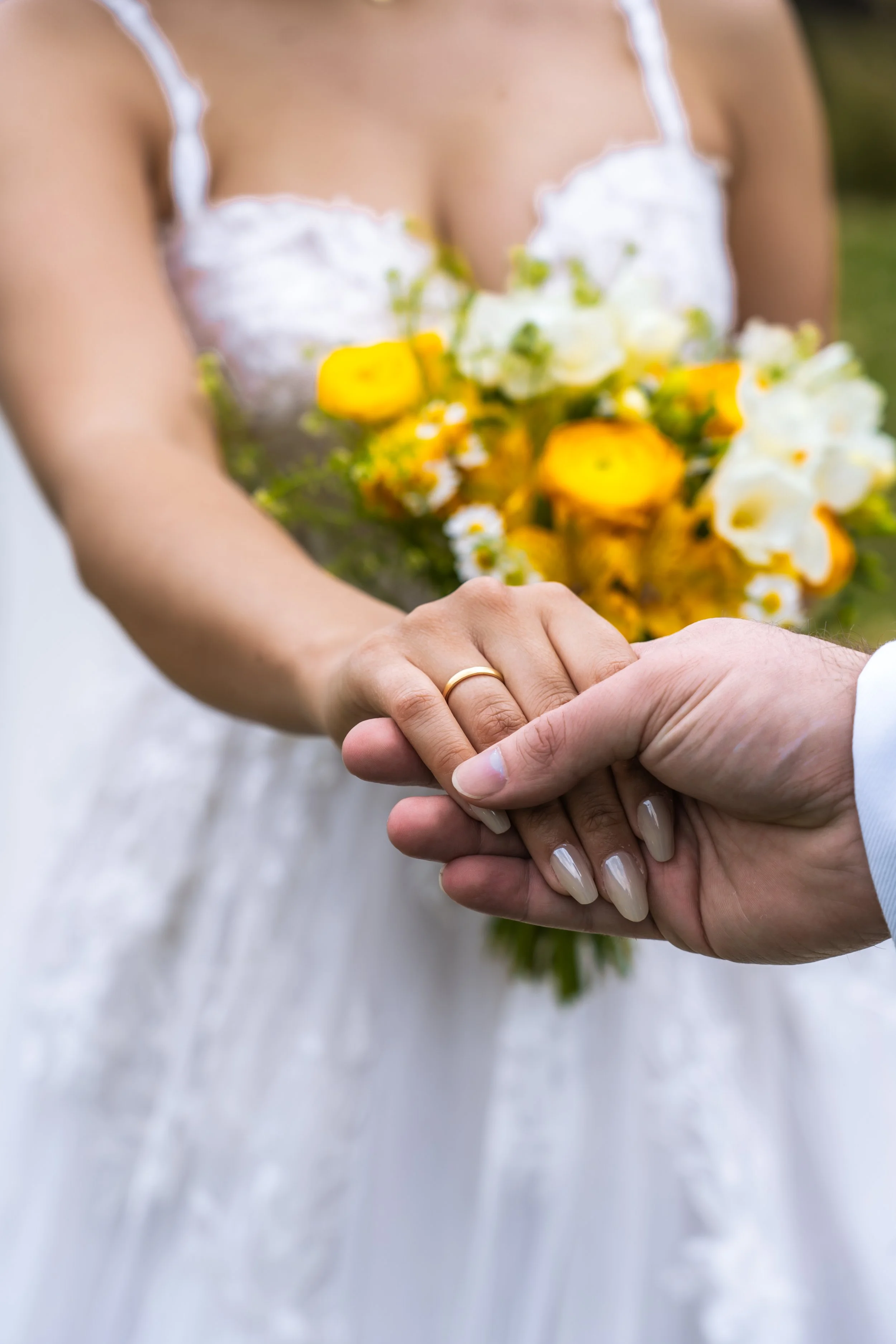 Eine Braut trägt einen Brautkleid und hält die Hand eines Bräutigams, während sie ein Blumenstrauß hält.