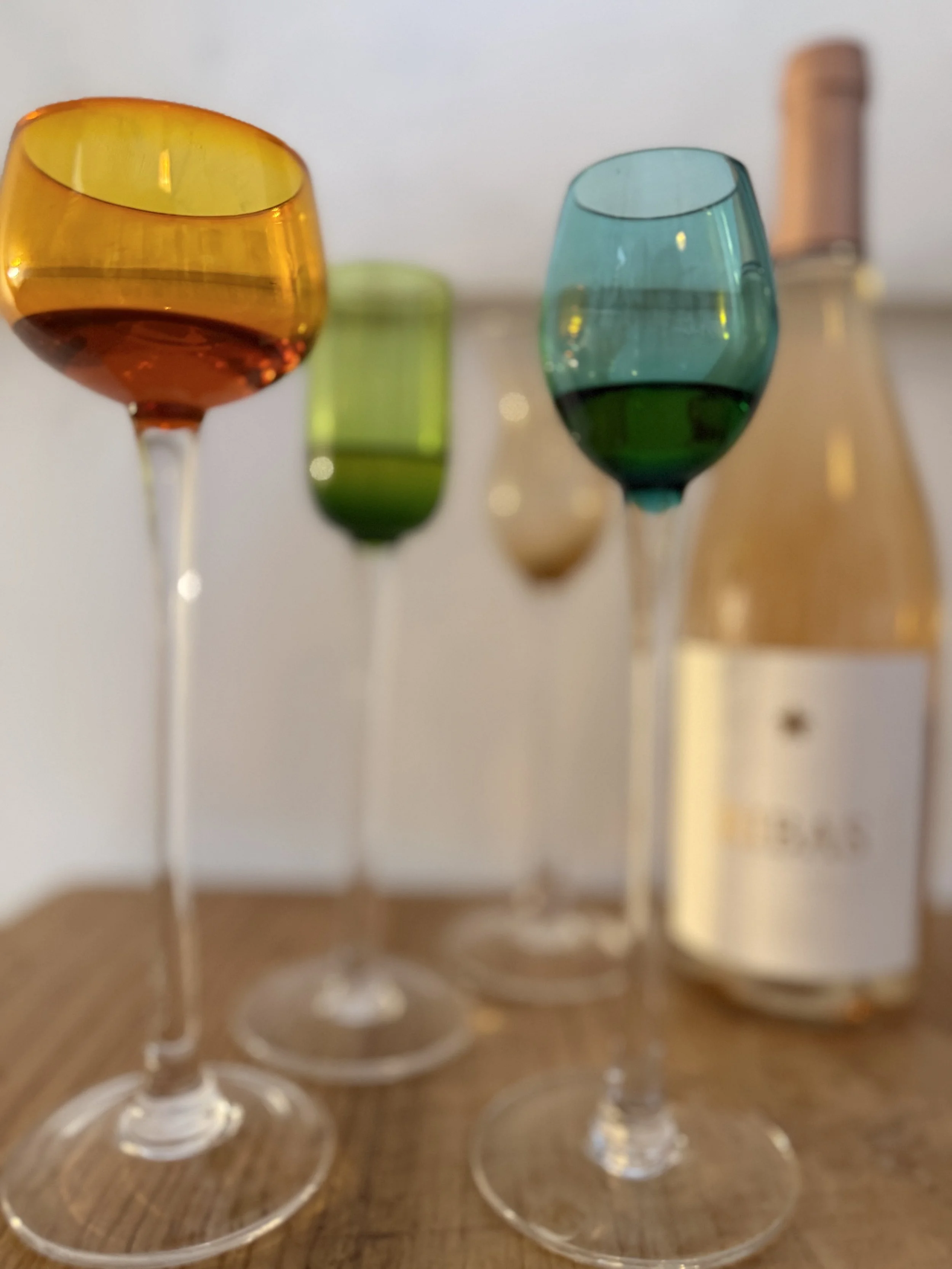 Cobalt blue and colored sensory glasses set up for an organic extra virgin olive oil tasting at Olea Club in Palma de Mallorca.