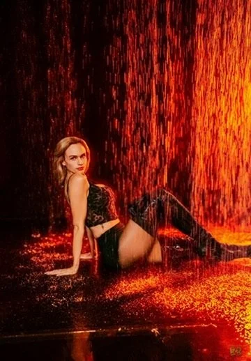 Photographer, for hire, Oceanside, Carlsbad, San Diego, Orange County, Fashion, Portraits, Moments, Lifestyle, Events, Branding.A woman sitting in a pool of glowing orange water with the backdrop of falling molten lava.