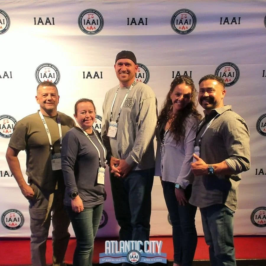 Group of five people standing in front of an IAAI event backdrop with the Atlantic City 2023 logo at the bottom.