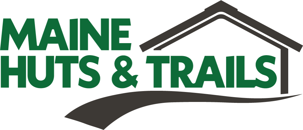 Logo for Maine Huts & Trails featuring stylized green and black text and a graphic of a building with a sloped roof.