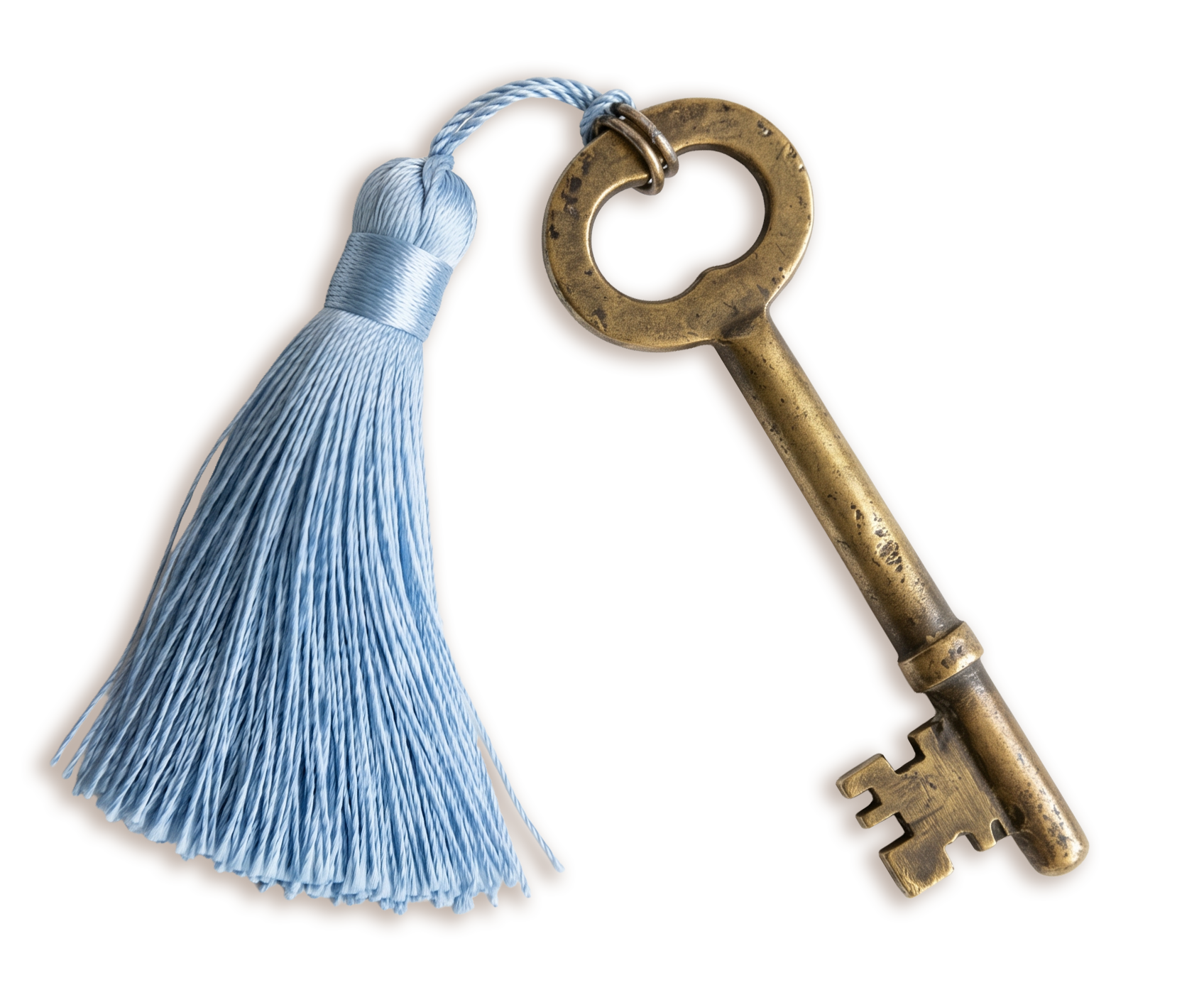 An antique brass skeleton key with a round handle and a small cut-out at the end, next to a light blue tassel with shiny silk threads.