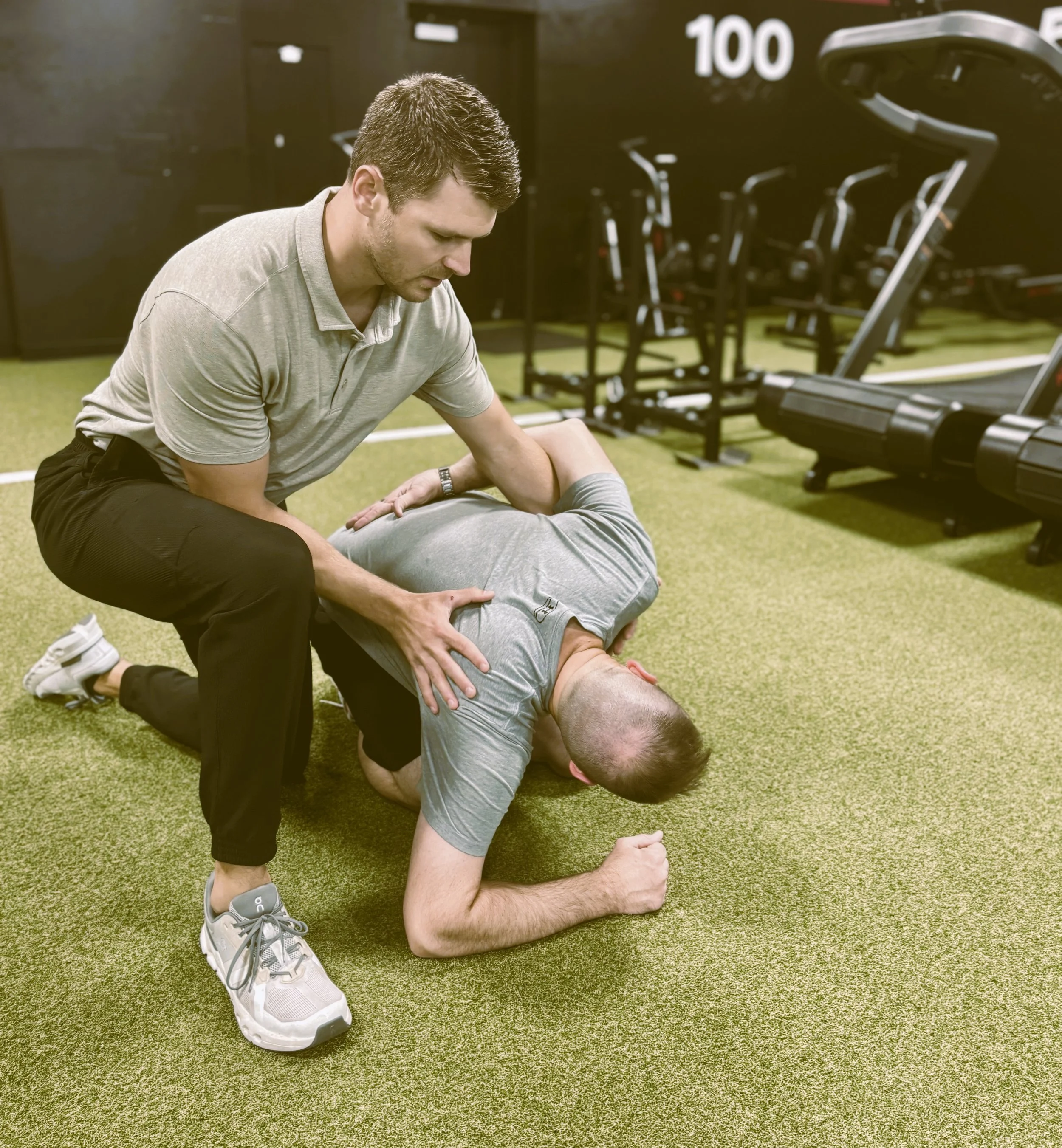 Best Physical therapist in Wichita guiding an adult through a side‑lying mobility and core stability exercise to improve movement, reduce pain, and enhance performance at a premium one‑on‑one clinic in east Wichita