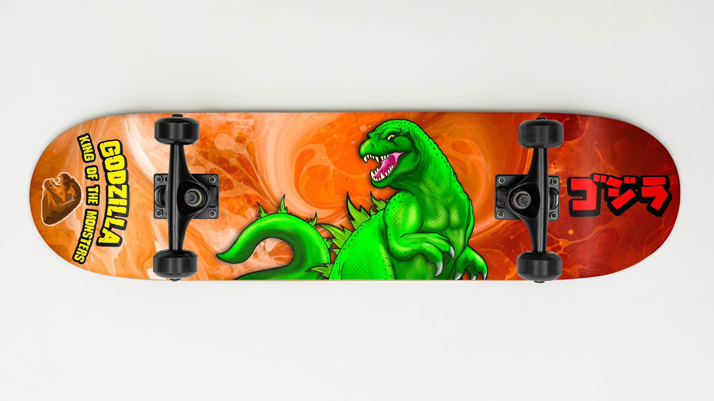 A skateboard with a bright orange background, featuring a green T-Rex dinosaur with an open mouth and sharp teeth, and black wheels.