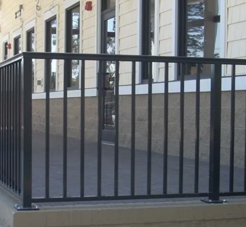 Aluminum Railing w/ Mushroom Cap & Flush Bottom. Anchored to Floor w/ Base Plates
