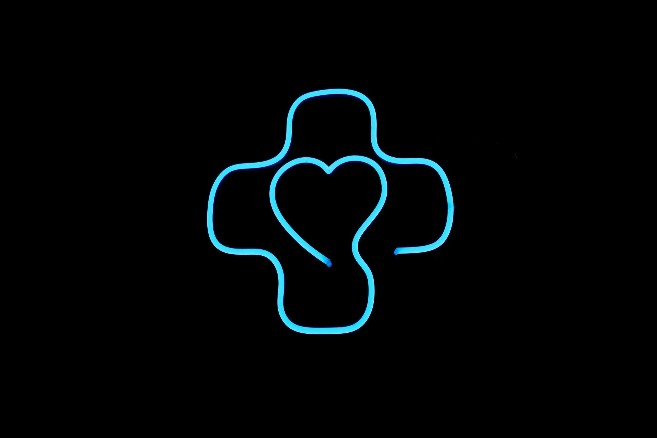 Blue neon outline of a hand making a finger heart gesture on a black background.