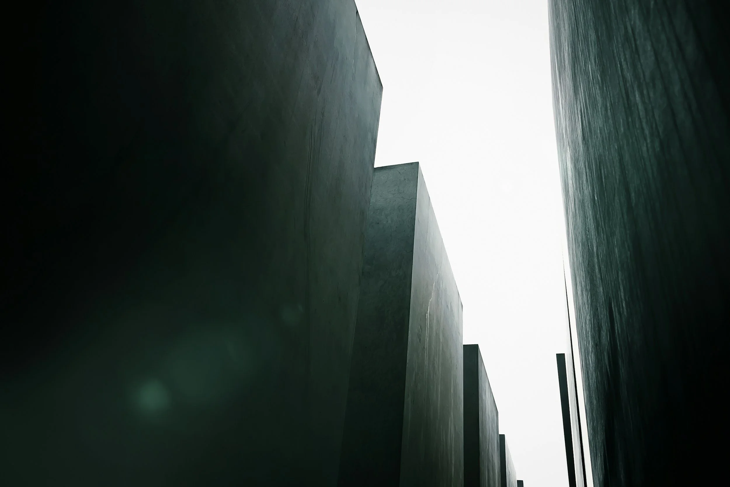 Abandoned concrete buildings in a modern architectural style, with a view of the sky in the background.