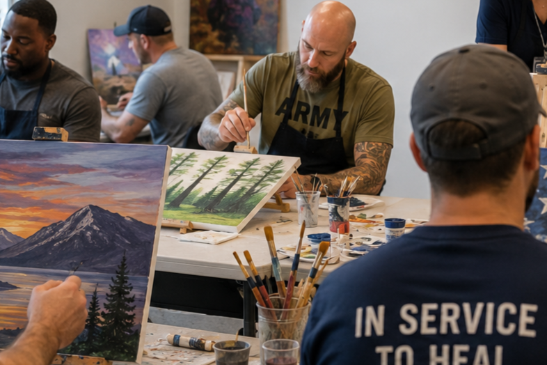 People painting landscape artworks at a group art class or workshop, with trees, mountains, and sunset scenes.