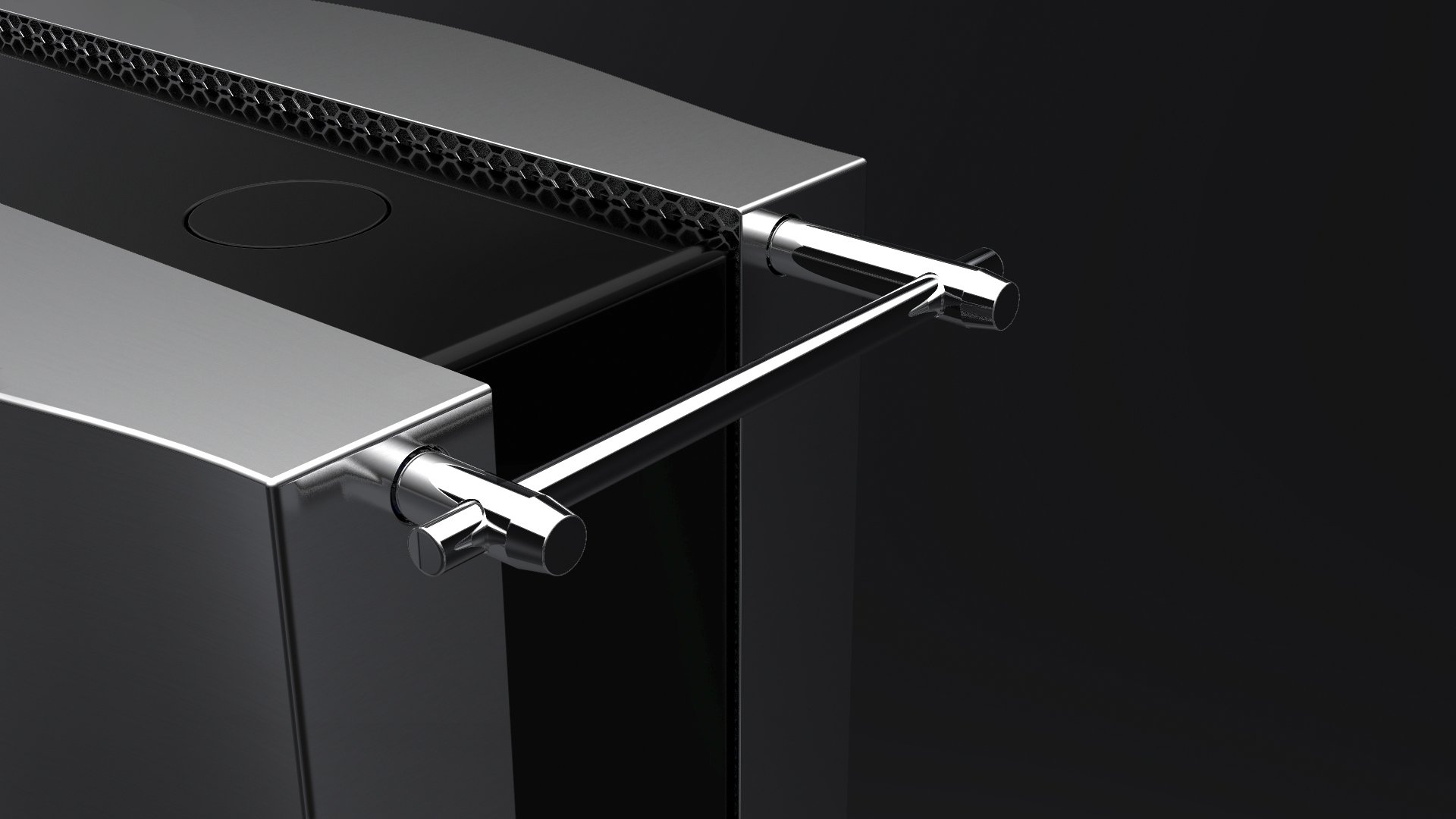 Close-up of a modern, metallic kitchen or industrial appliance with a black surface, cylindrical handles, and a textured vent or grille on top, set against a dark background.