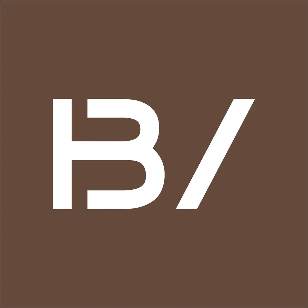 Brown background with white text displaying 'B/' in a bold font.