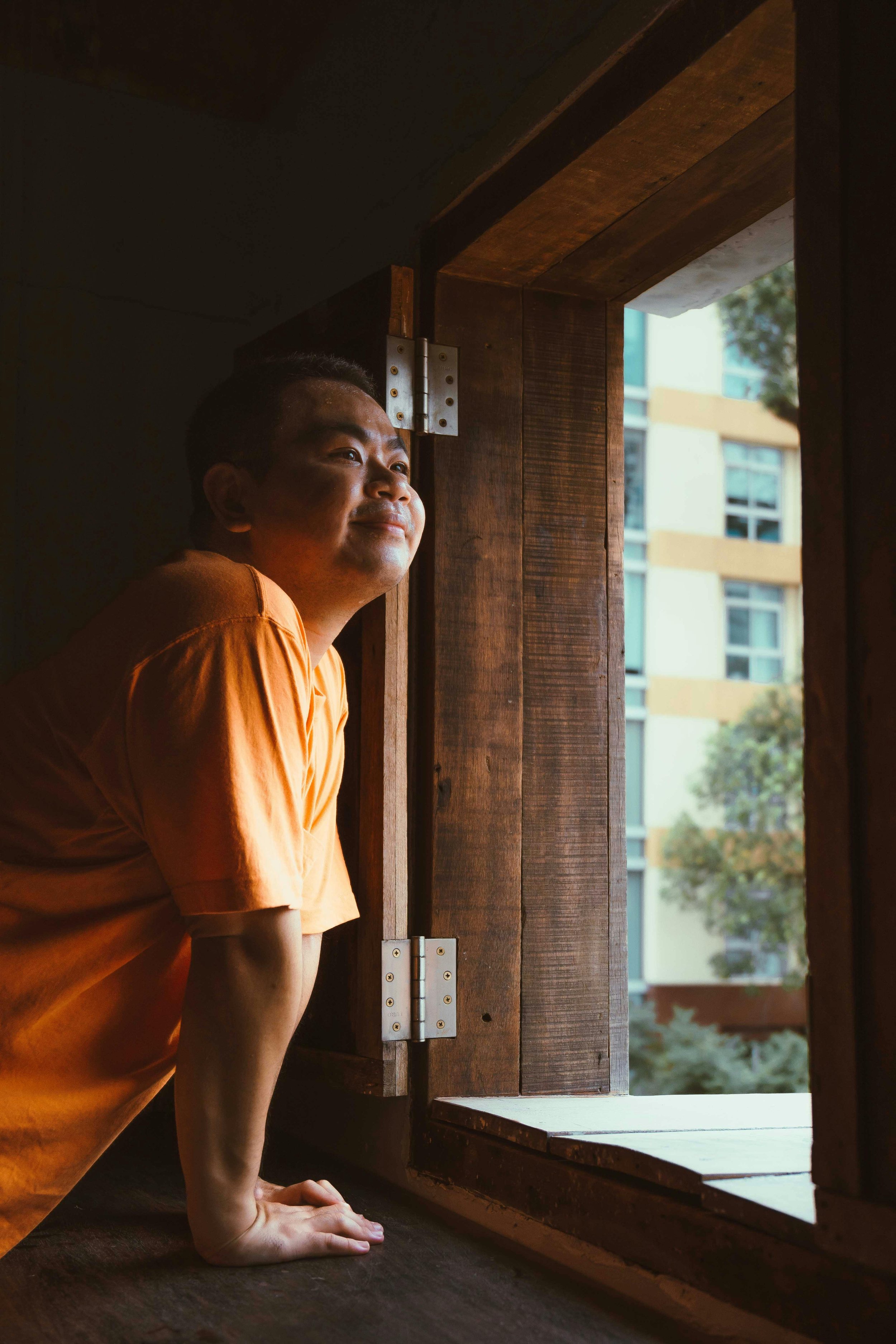 Man looking out a doorway contemplating starting therapy