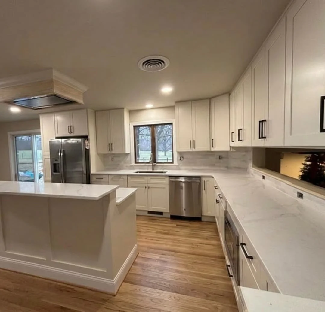 Open-concept kitchen remodel in Perkasie, PA featuring custom shaker cabinets, quartz countertops, large island, and stainless steel appliances.