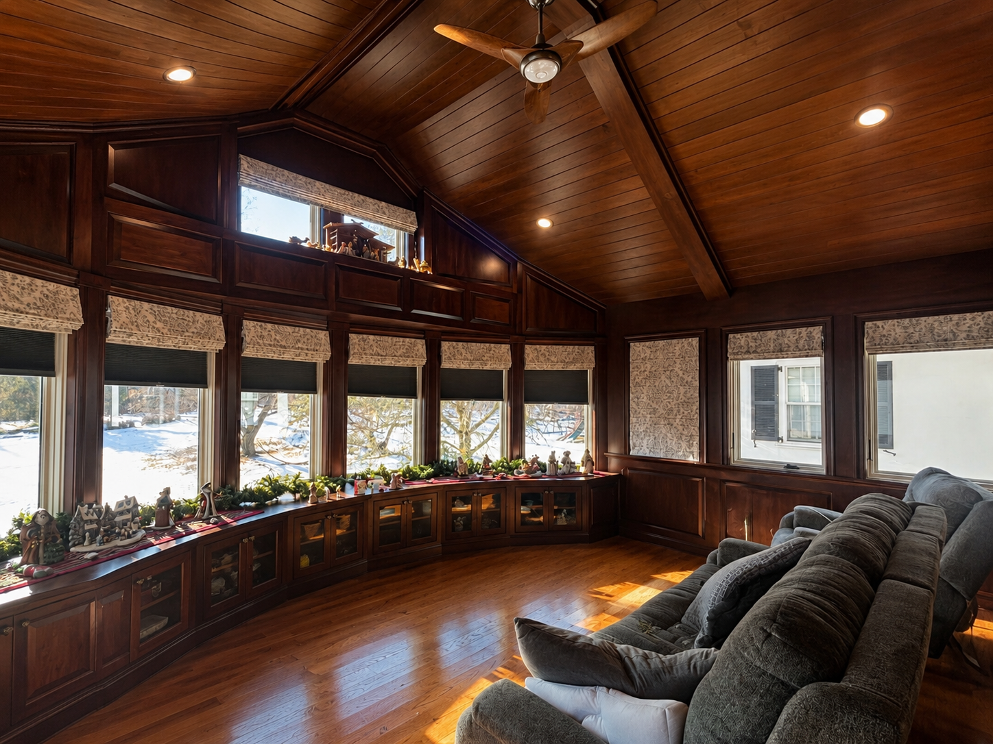 JWD Contractors second-story sunroom addition in Ambler, PA with custom woodwork, vaulted wood ceiling, built-in cabinetry, and large windows.