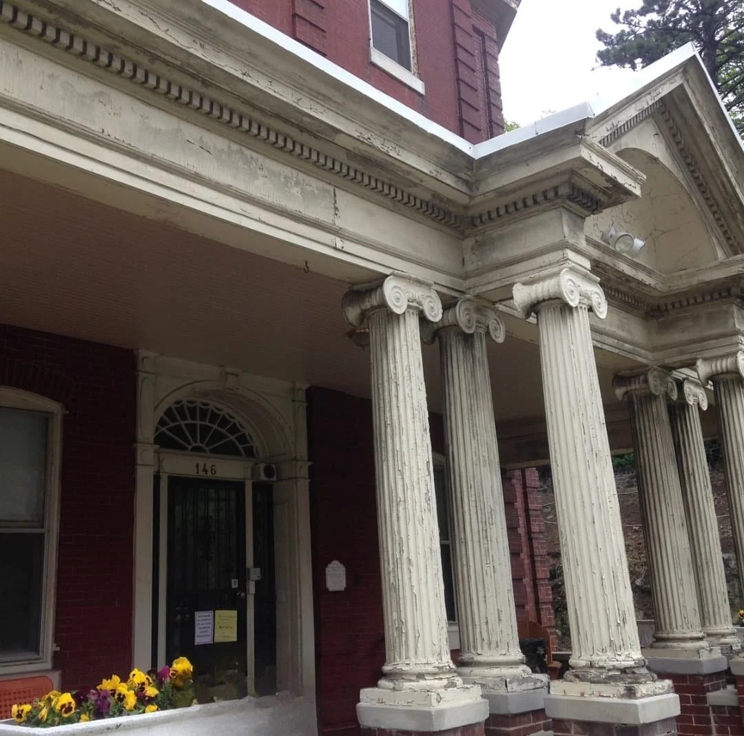 Original deteriorated front porch in Doylestown, PA before restoration of the columns, trim, and architectural details.