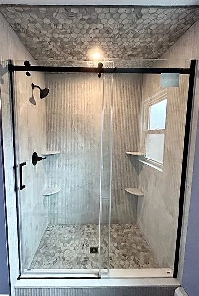 A outdated Hatboro, PA full bathroom remodel featuring a custom mosaic tiled walk-in shower and a dual vessel sink, completed by JWD Contractors.