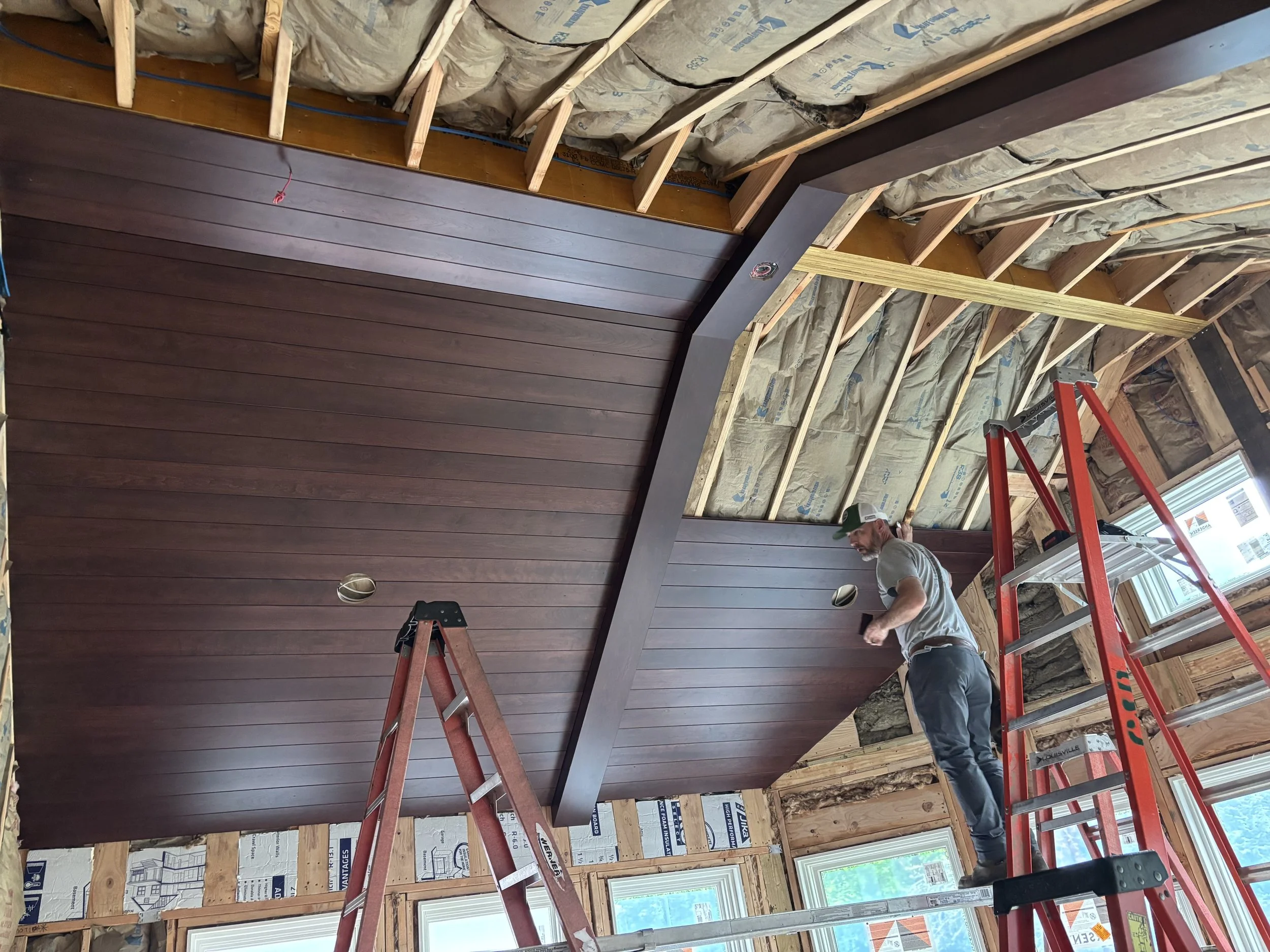Interior construction of an Ambler, PA home addition showing wood ceiling installation, exposed beams, and insultation.