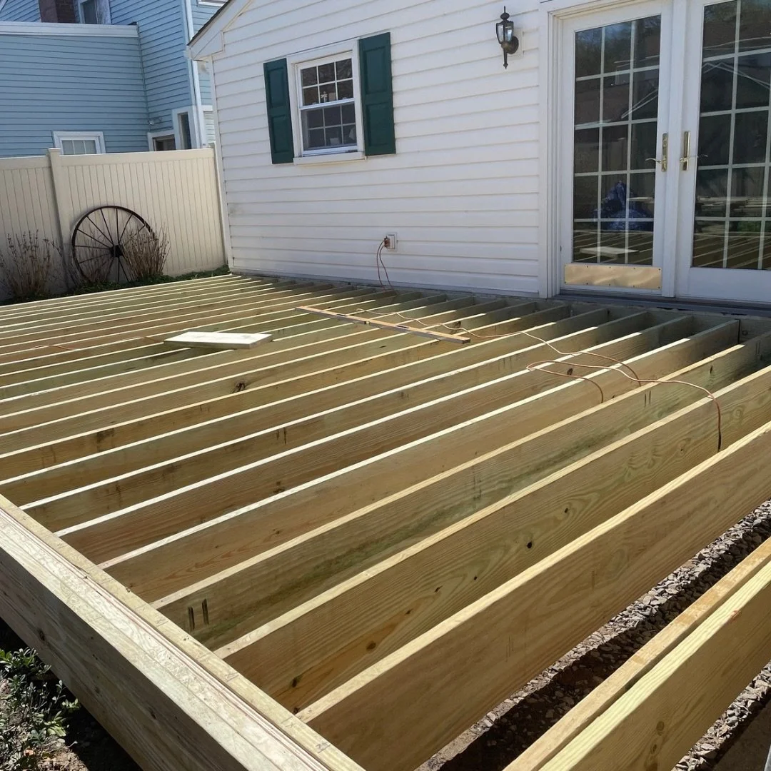 Deck substructure with pressure-treated wood joists during construction in Warrington, PA