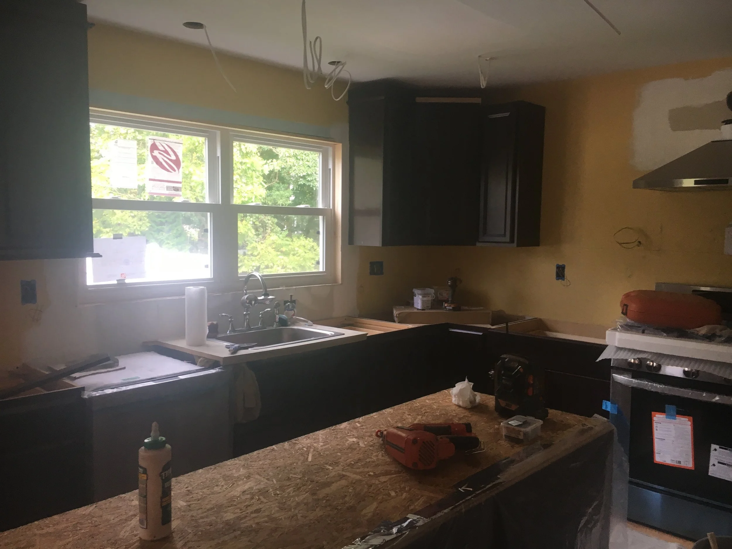 Kitchen before remodeling with existing dark cabinetry, countertops, sink, and original layout prior to JWD Contractors renovation.