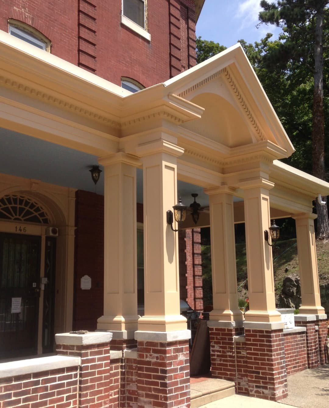 Finished Doylestown, PA porch restoration with rebuilt columns, decorative trim, brick bases, and restored architectural details.
