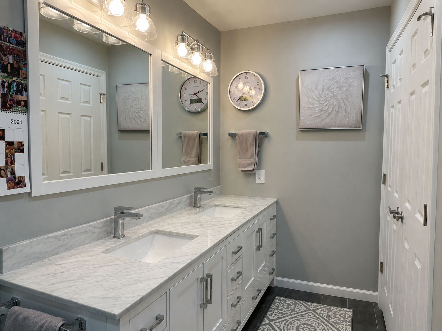 Long double vanity with drawers, cabinet storage, two sinks, and mirrored medicine cabinets in a Upper Moreland Township bathroom remodel.