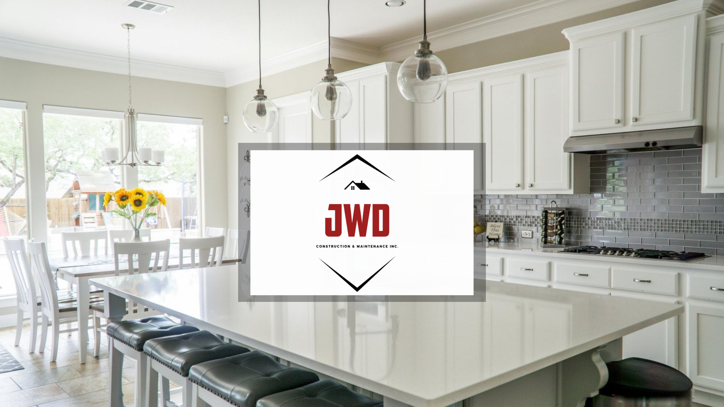 Newly renovated and remodeling white kitchen with natural sun and pendant lighting with JWD logo in center