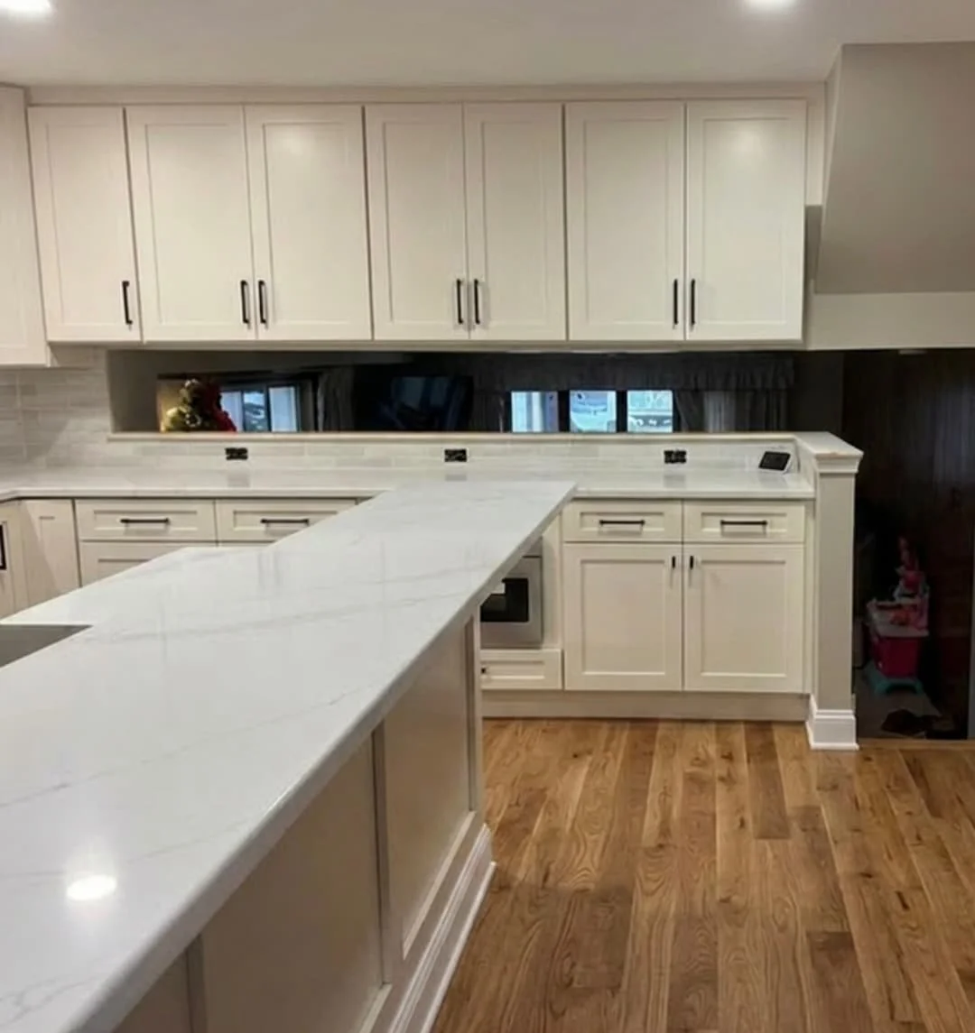 Quartz waterfall-style countertop, custom shaker cabinets, and spacious island in a professionally remodeled kitchen in Perkasie, PA.