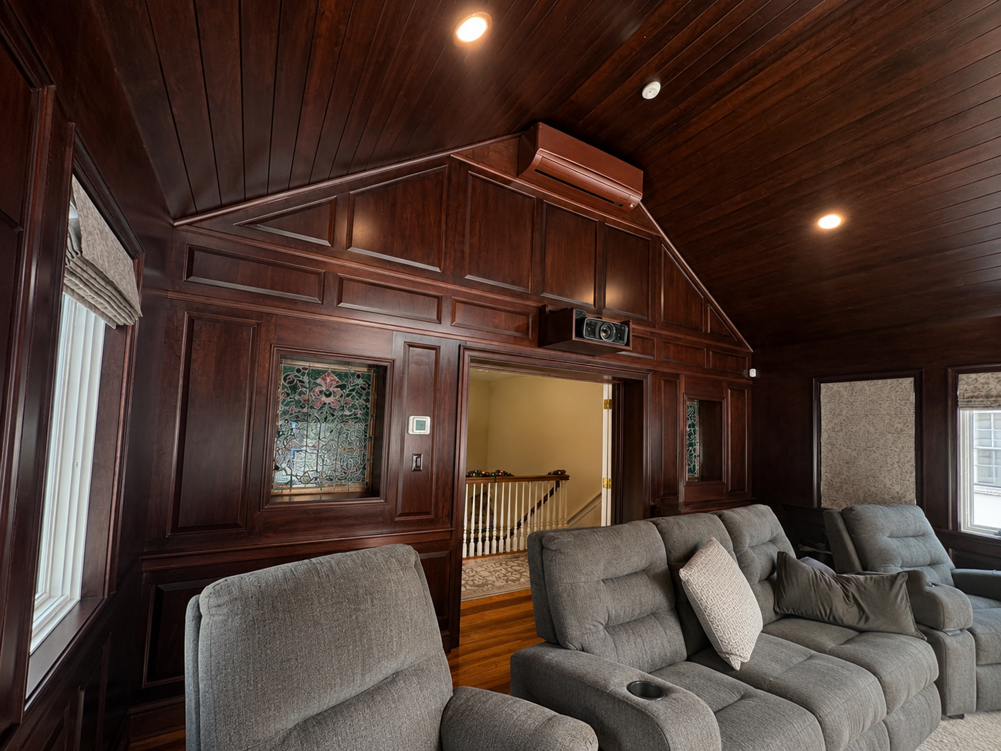 Finished Ambler, PA sunroom addition with custom woodwork wall panels, vaulted wood ceiling, exposed beams, and built-in architectural details.