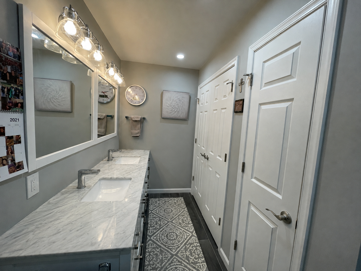Double-sink vanity in a Upper Moreland Township bathroom remodel with quartz countertop, recessed medicine cabinets, and added storage.