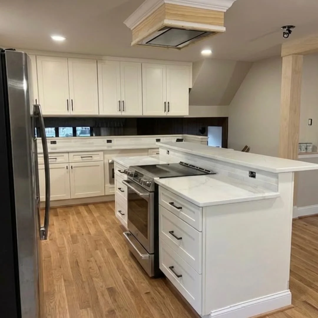 Custom range hood and waterfall island in a Perkasie, PA kitchen remodel completed by JWD Contractors.