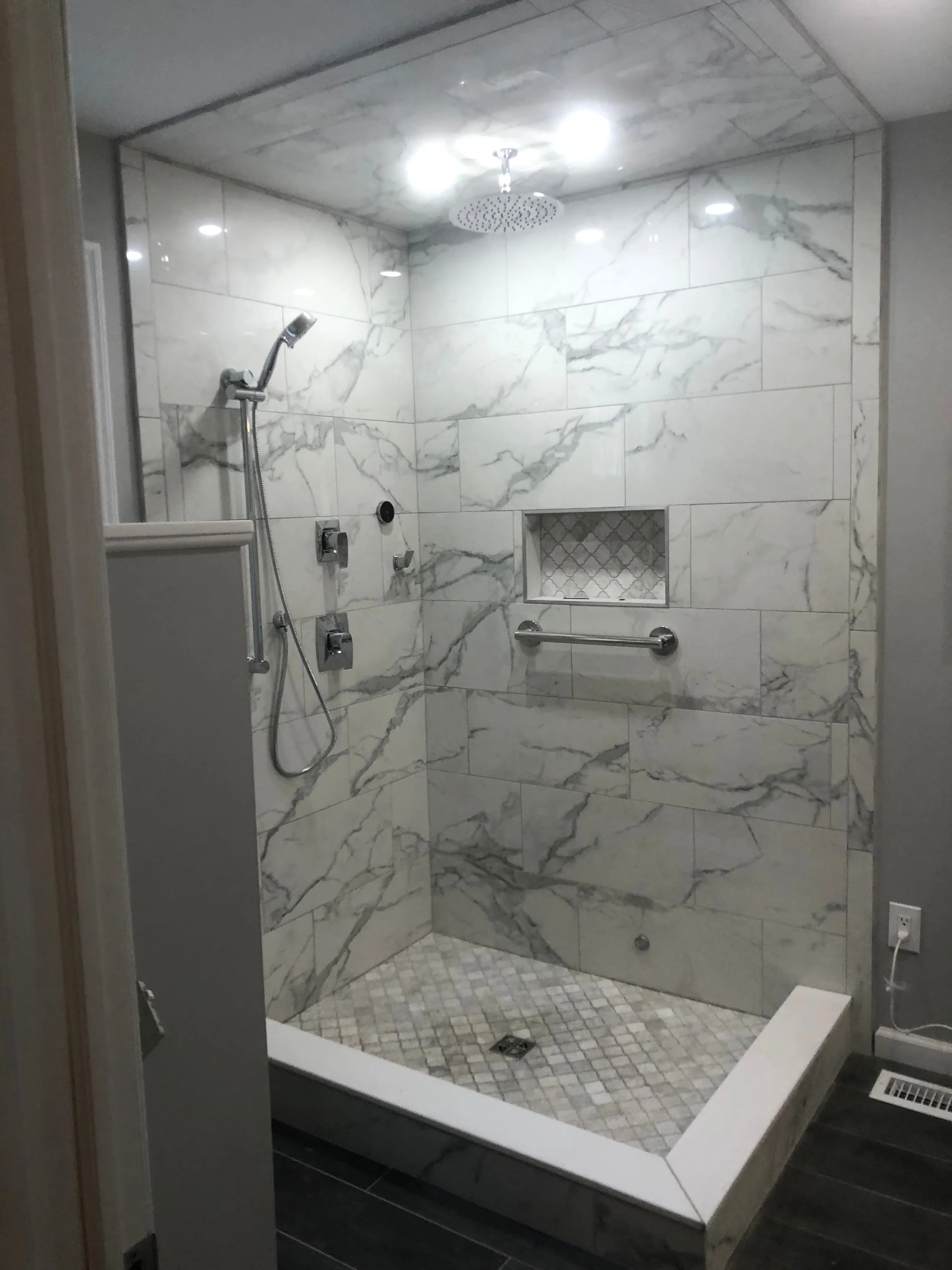 Completed tile in walk in shower with fixtures added frameless door is next Hatboro pa bathroom renovation