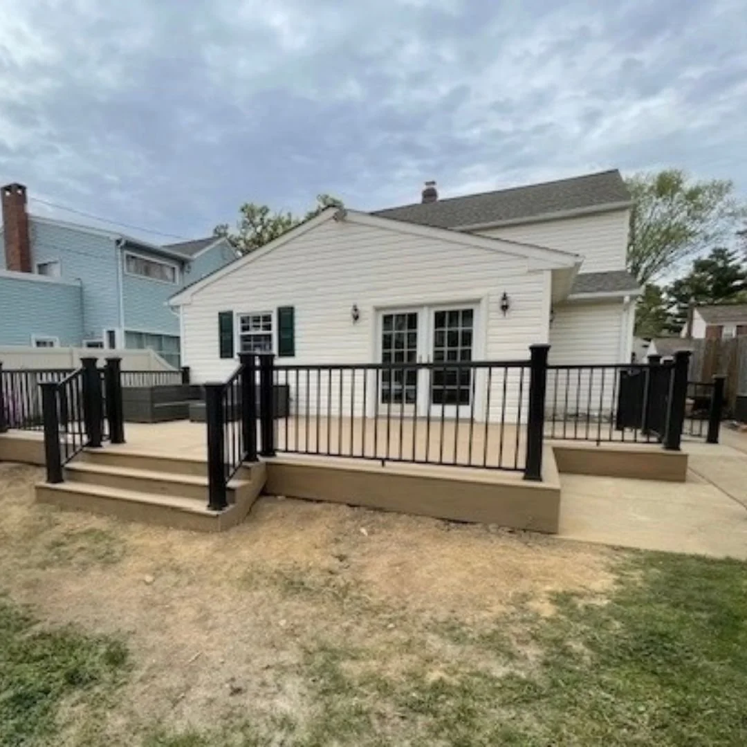 Completed composite deck on multi-level design with black railing and steps in Warrington, PA