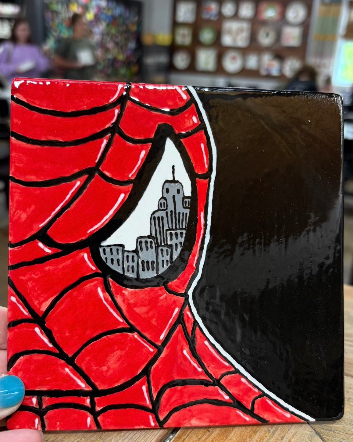 This hand painted spider man plaque turned out amazing! 

And you don&rsquo;t even need to have any drawing skills to make your own spider man pottery! We have tracing tools that allow you to trace any image onto your piece, and then you just have to