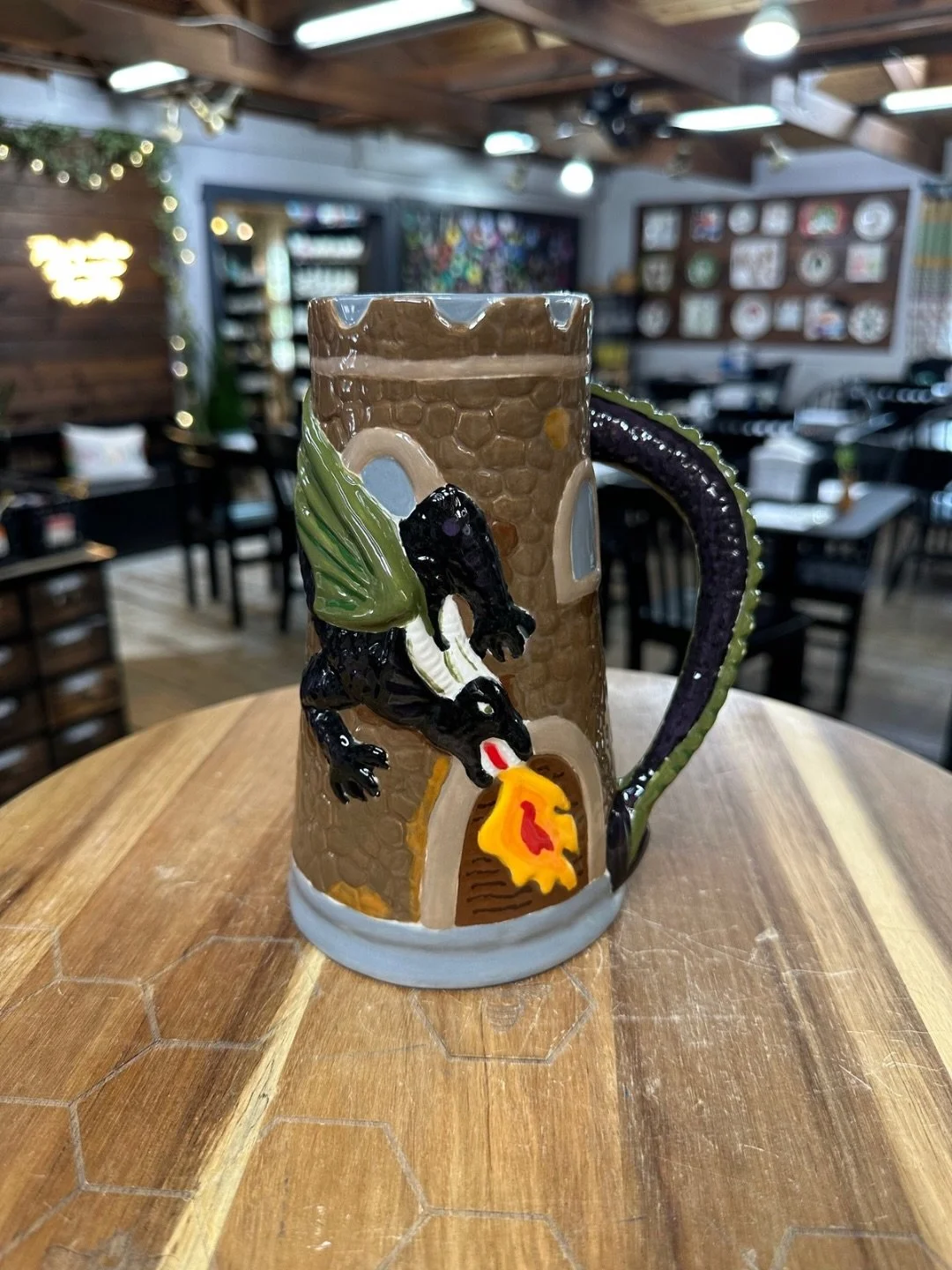 Same dragon stein painted 2 different ways! Both are amazing!! 

The first one used our regular glazes, these are brighter colors that we dip in a clear glaze to make shiny. 

The second one used our specialty glazes. These have a range of different 