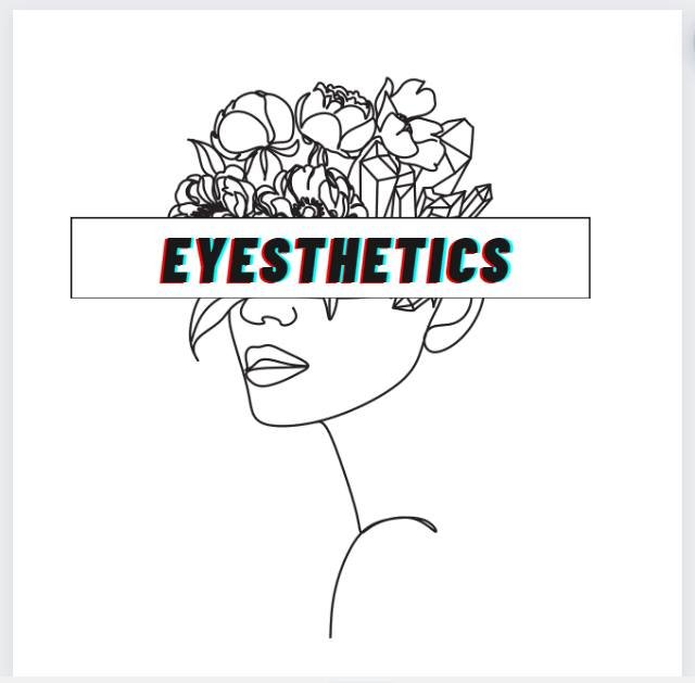 Line drawing of a woman's face with flowers and crystals as her hair, with a white rectangle across her eyes containing the word 'EYSTHETICS' in bold, stylized font.