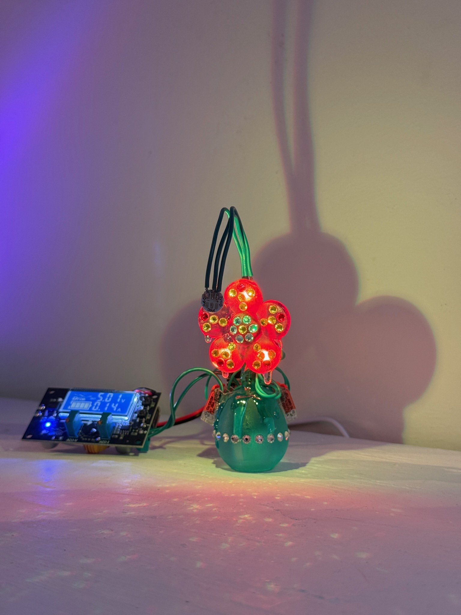 Flower charm lamp (flower that lights itself)
 | 
2026 | 
Dimensions variable: Height about 4 inches | 
Resin, metal-backed crystals, automotive paint | 850USD