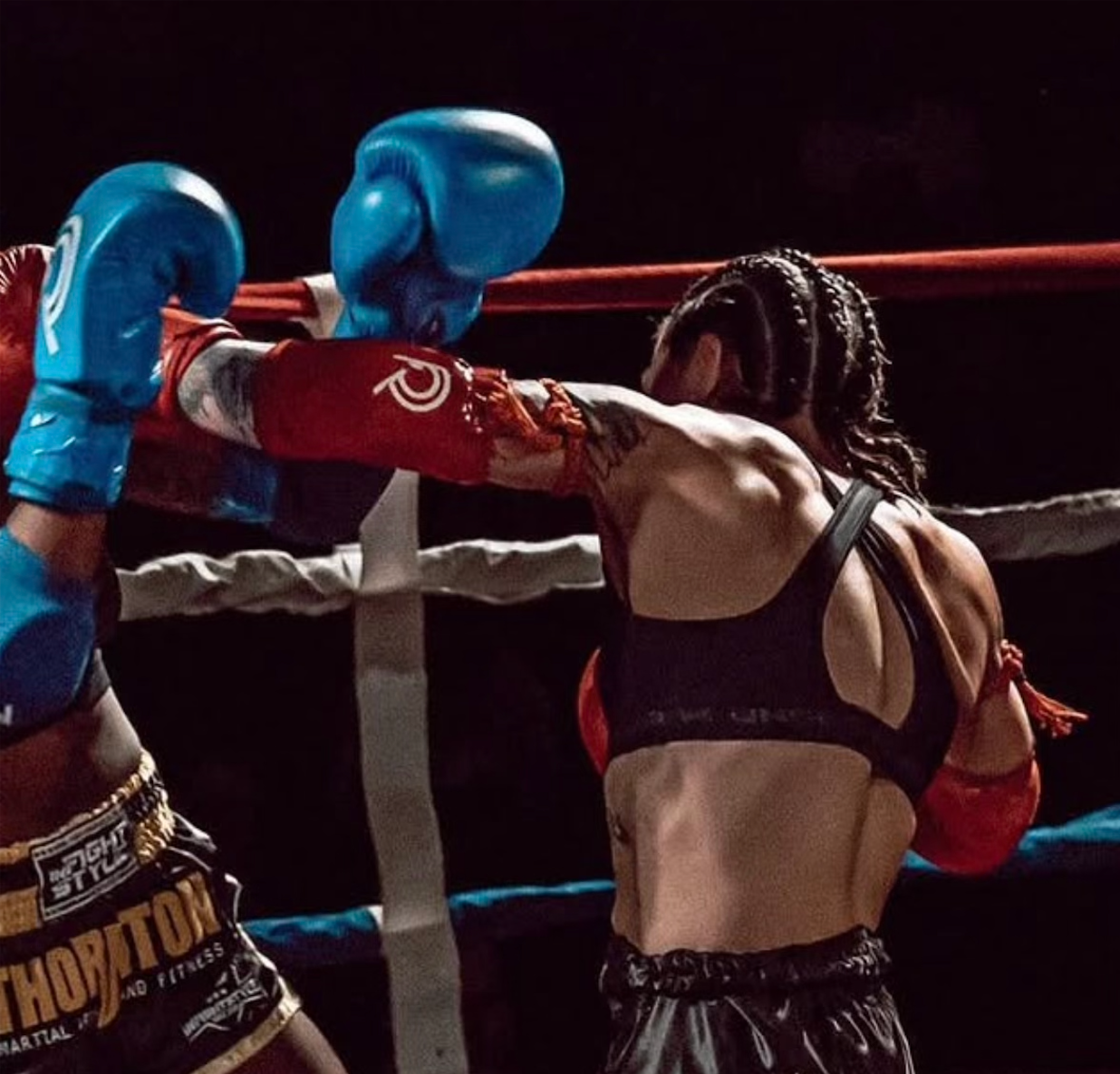 Action shot of XInghun Hector Wang mid muay thai fight.