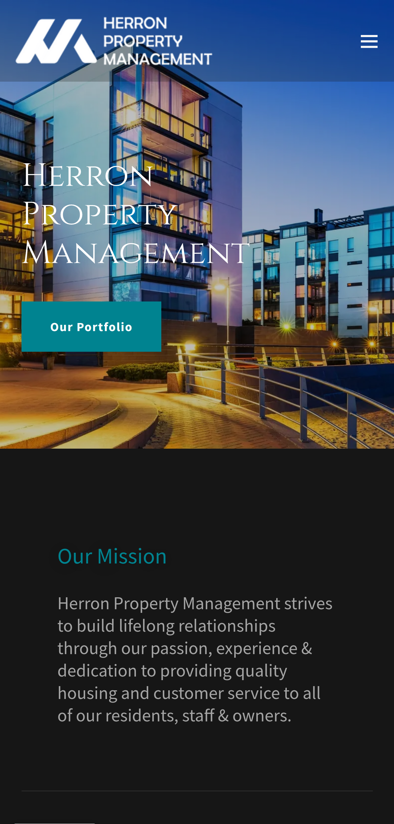 Modern apartment complex with glass balconies illuminated at dusk, part of Herron Property Management website homepage.