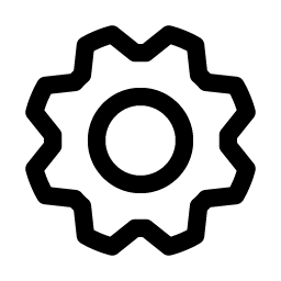 A silhouette of a person standing on a hillside, with a tree nearby, against a sky at sunset or sunrise.