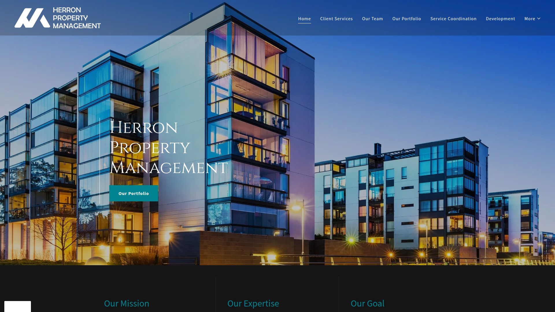 Modern multi-story residential buildings with glass facades illuminated at dusk in Herron Property Management website.