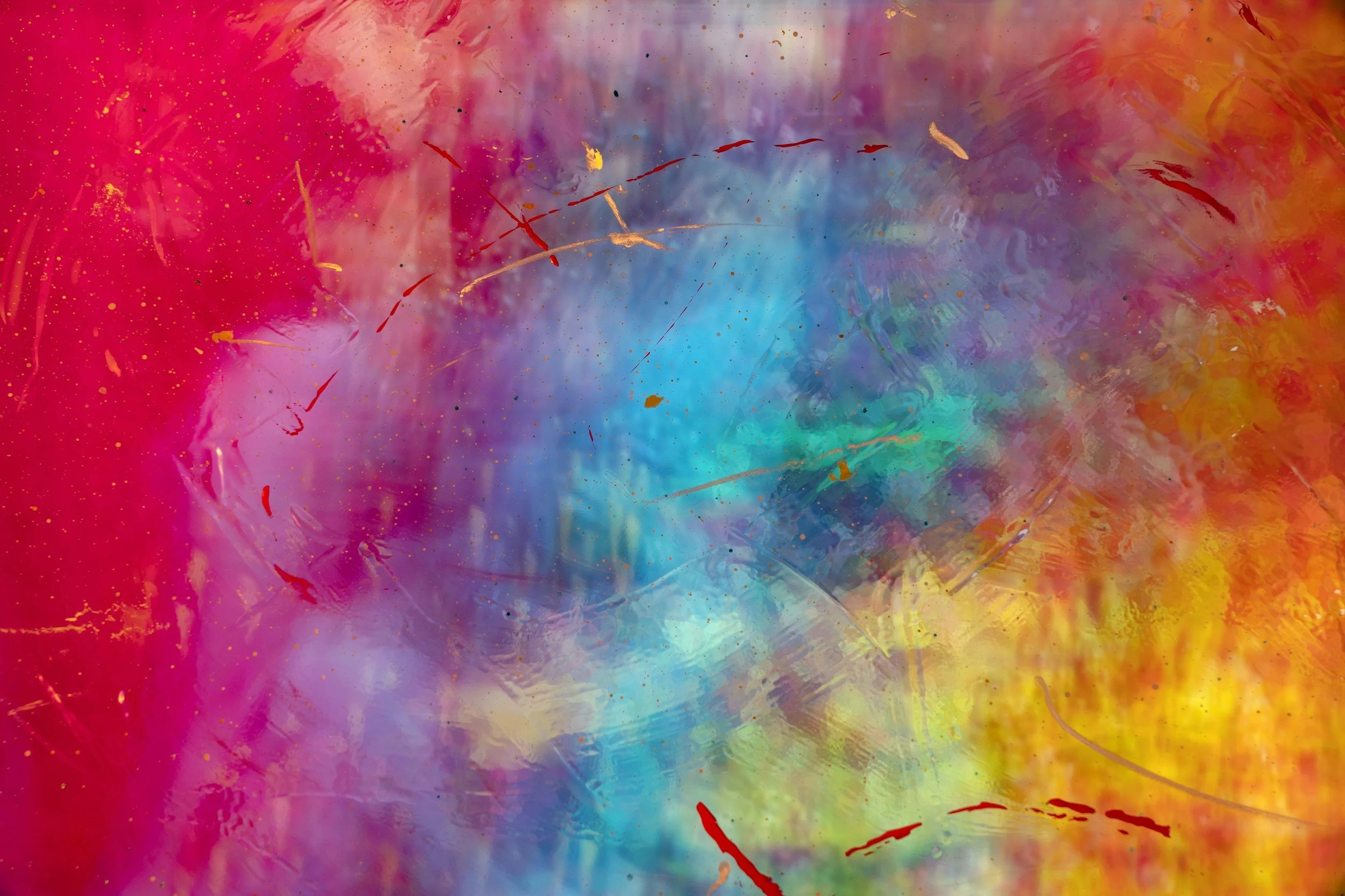 Abstract multicolored background with splashes of pink, purple, blue, yellow, orange, and red paint and gold accents.