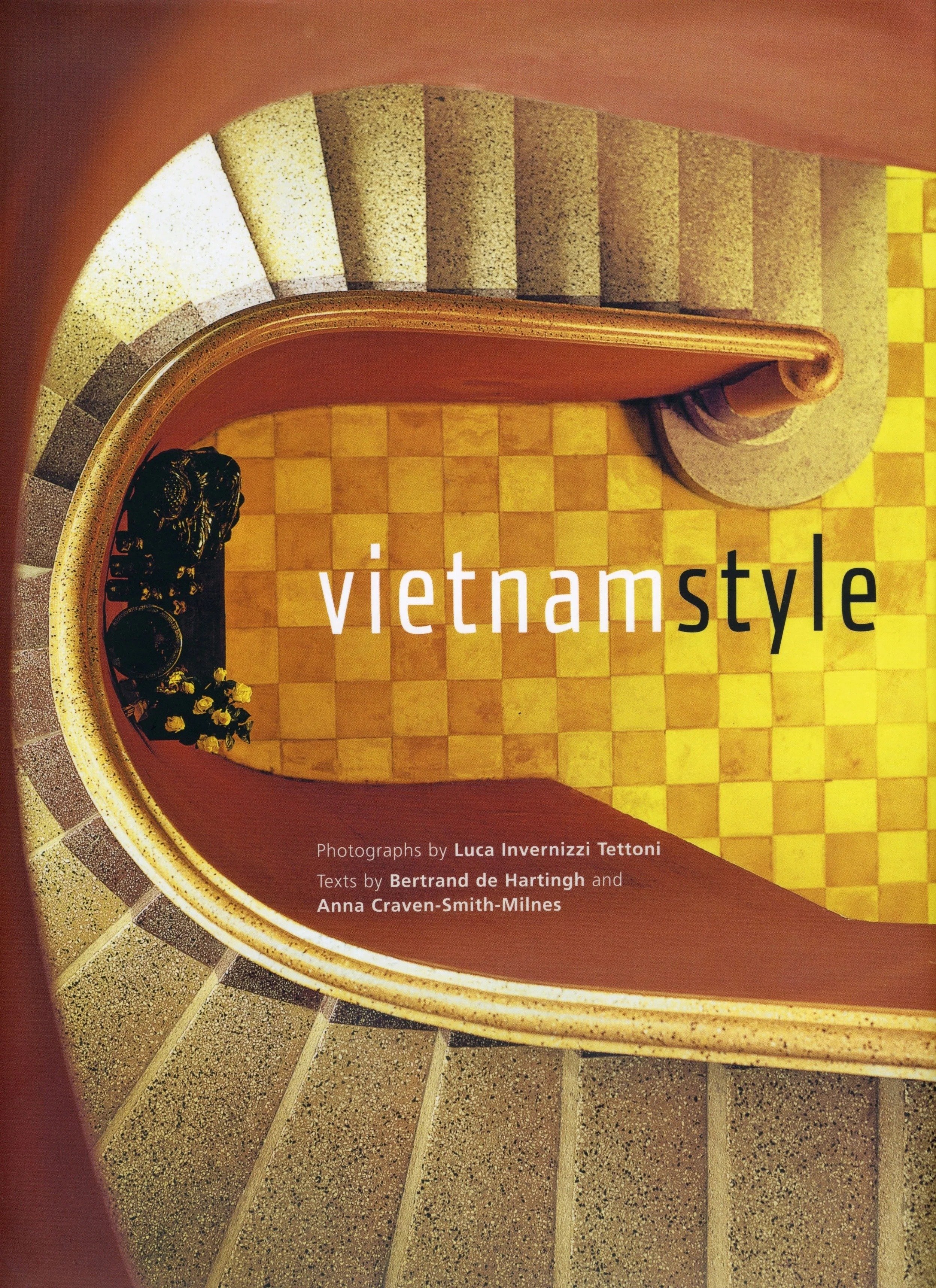 Cover of a book titled 'vietnamstyle' with a photograph of a spiral staircase with yellow and black checkered tiles on the floor and a scalloped grey stone railing, taken from above by Luca Invernizzi Tettoni.